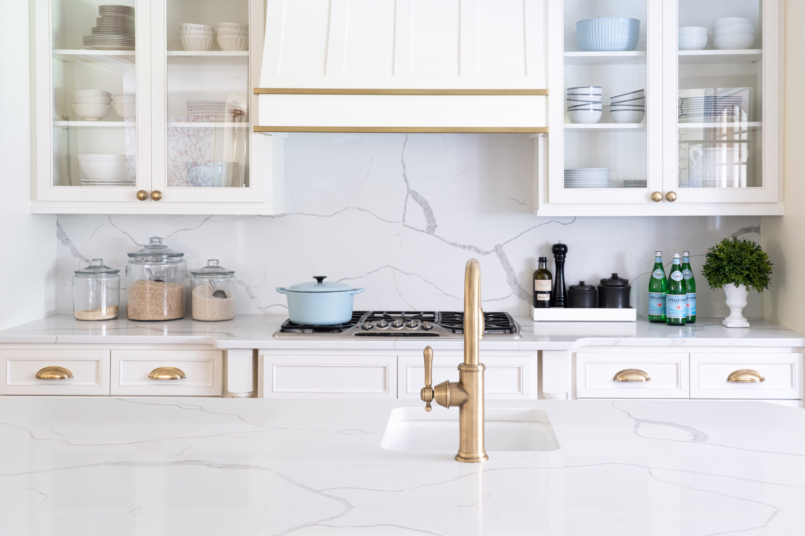 kitchen with white cabinets and brass hardware